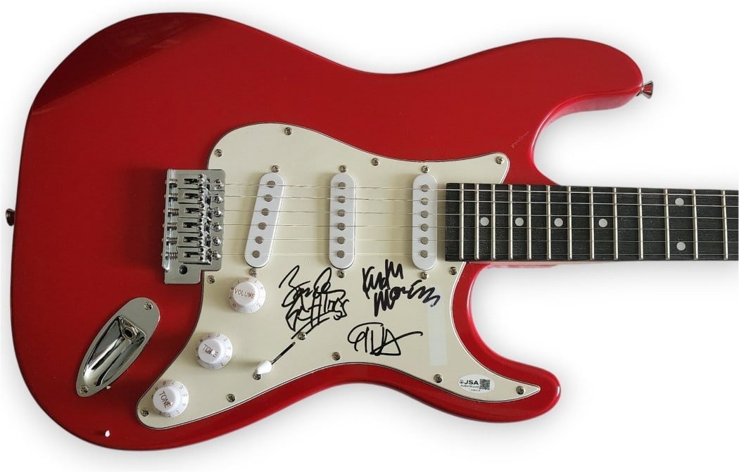 Guitar Signed by Circle Jerks Members JSA Authenticated: Guitar Signed by Circle Jerks Members JSA Authenticated This original guitar, accompanied by a guitar pick, is autographed by Circle Jerks band members Keith Morris, Greg Hetson, and Zander Schloss. T