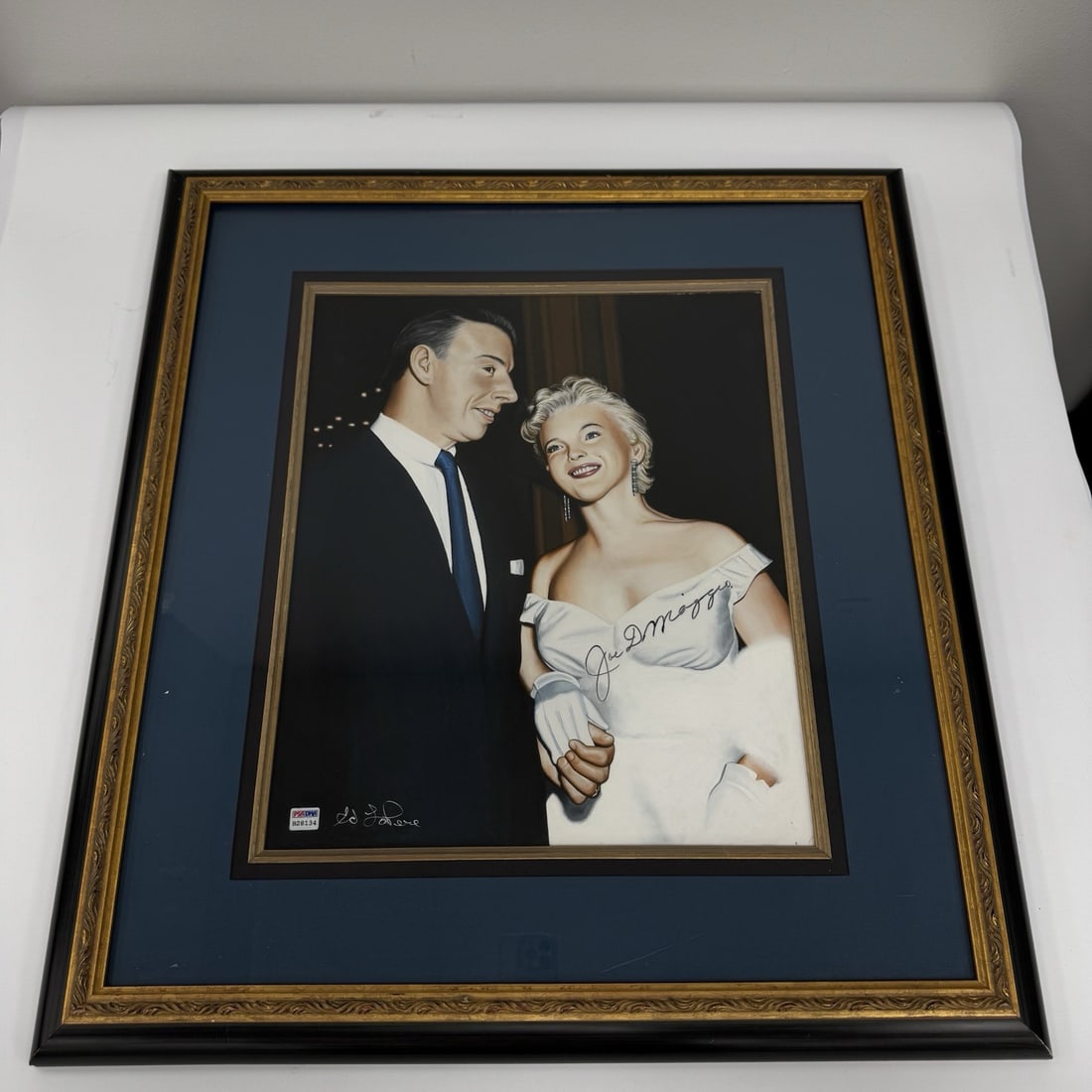 Rare Joe DiMaggio Signed Ed LoPere Painting with PSA JSA COA: Rare Joe DiMaggio Signed Ed LoPere Painting with PSA JSA COA This unique piece of art features an original painting by Ed LoPere, depicting the iconic duo Joe DiMaggio and Marilyn Monroe during the pr