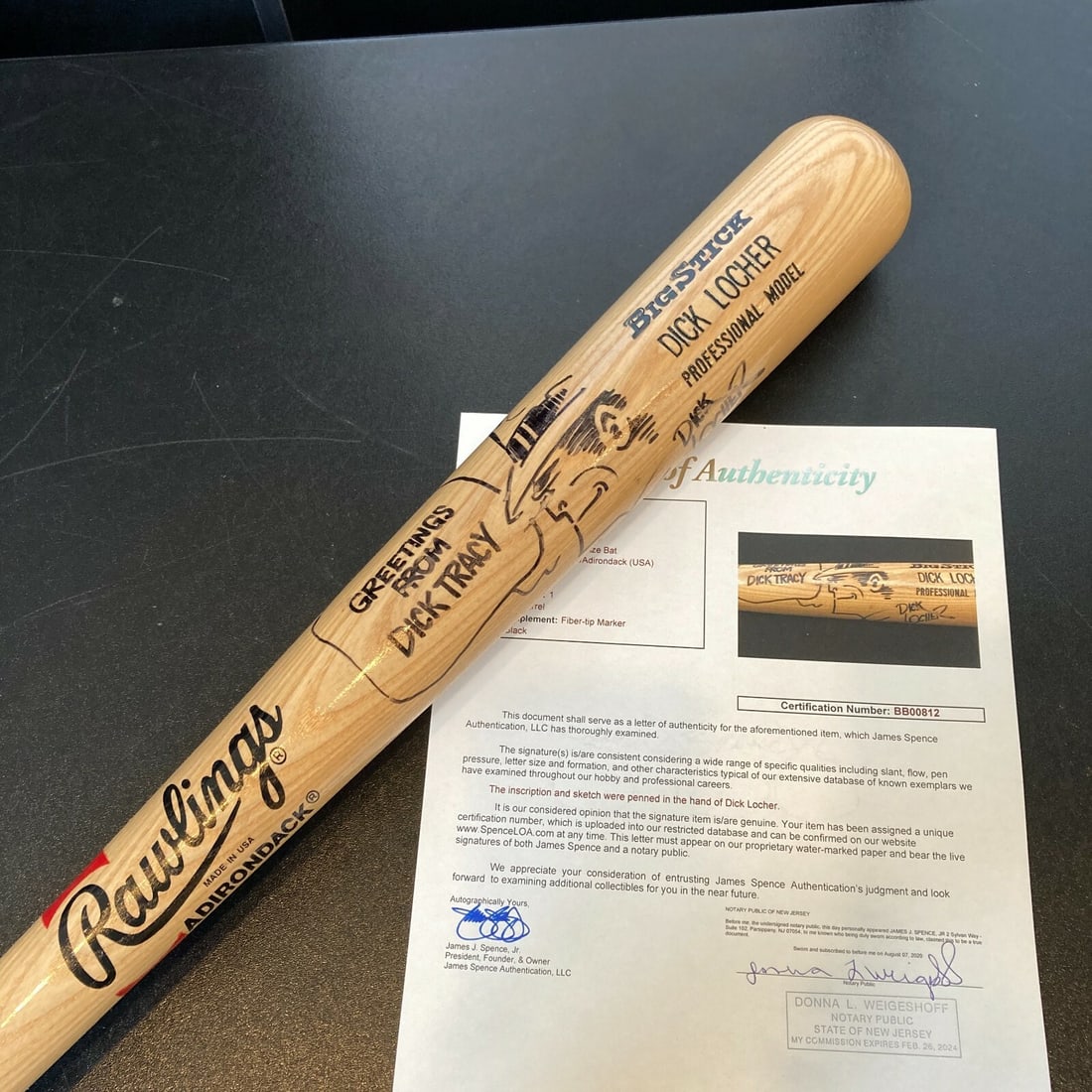 Dick Locher Signed Rawlings Bat with Dick Tracy Art JSA Authenticated: Dick Locher Signed Rawlings Bat with Dick Tracy Art JSA Authenticated This special edition Rawlings baseball bat features the signature and hand-drawn cartoon art of renowned cartoonist Dick Locher, b