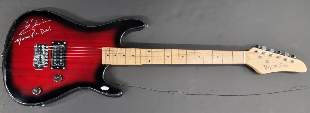 Cassandra Peterson Elvira Signed Electric Guitar JSA Authenticated: Cassandra Peterson Elvira Signed Electric Guitar JSA Authenticated This authentic electric guitar is signed by Cassandra Peterson, famously known as Elvira. The autograph has been certified by James S