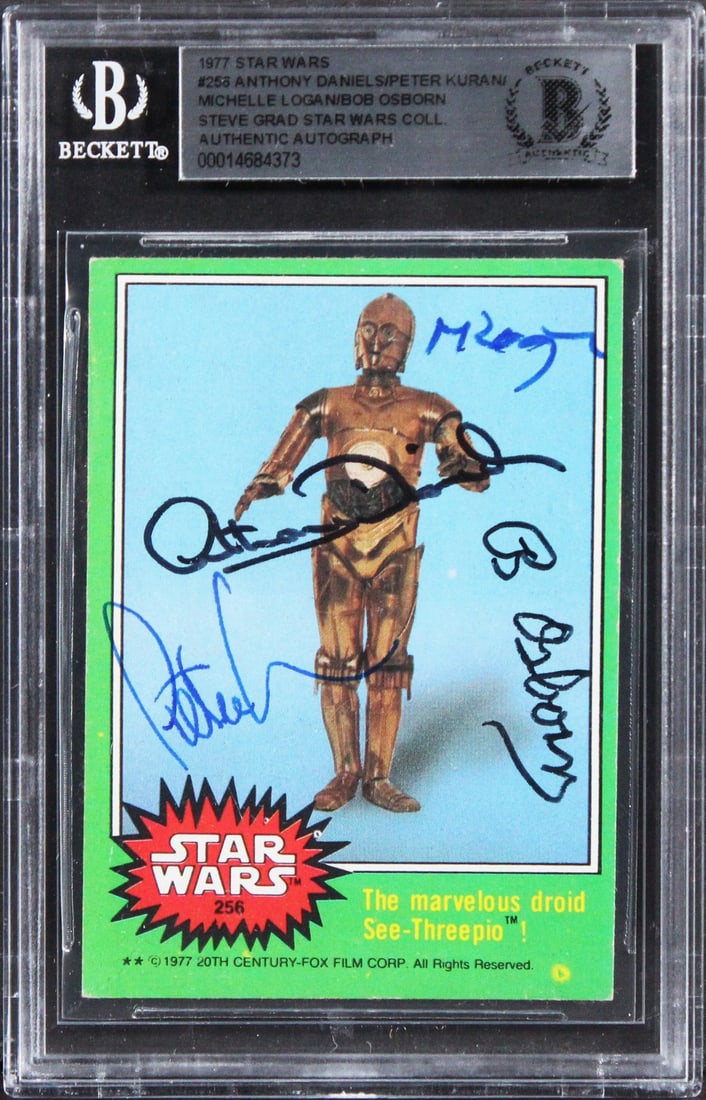 1977 Star Wars Card #256 With Four Signatures Beckett Authenticated Slab: 1977 Star Wars Card #256 With Four Signatures Beckett Authenticated Slab This 1977 Star Wars #256 trading card has been personally signed by Anthony Daniels, Peter Kuran, Michelle Logan, and Bob Osbor