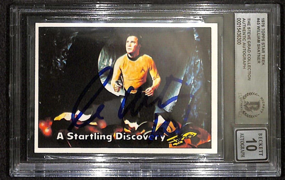 William Shatner Signed 1976 Topps Star Trek #45 Beckett 10: William Shatner Signed 1976 Topps Star Trek #45 Beckett 10 This is a 1976 Topps Star Trek trading card featuring Captain Kirk, signed by the legendary actor William Shatner. The autograph is inscribed
