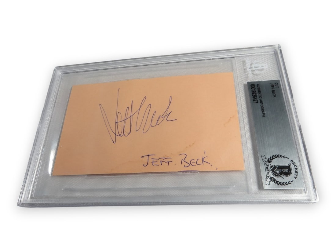 Beckett Authenticated Jeff Beck Hand Signed Cut Signature Encapsulated: Beckett Authenticated Jeff Beck Hand Signed Cut Signature Encapsulated This is an original cut signature autographed by Jeff Beck, renowned guitarist of The Yardbirds. The signature has been professio