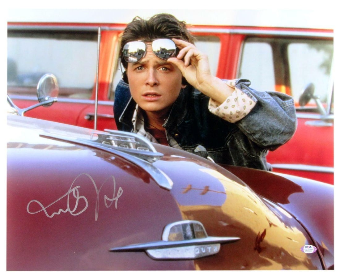 Michael J Fox Autographed 16x20 Back to the Future Photo PSA/DNA: Michael J Fox Autographed 16x20 Back to the Future Photo PSA/DNA Celebrate the timeless classic with this authentic 16x20 photo from "Back to the Future," personally signed by Michael J. Fox. This rem