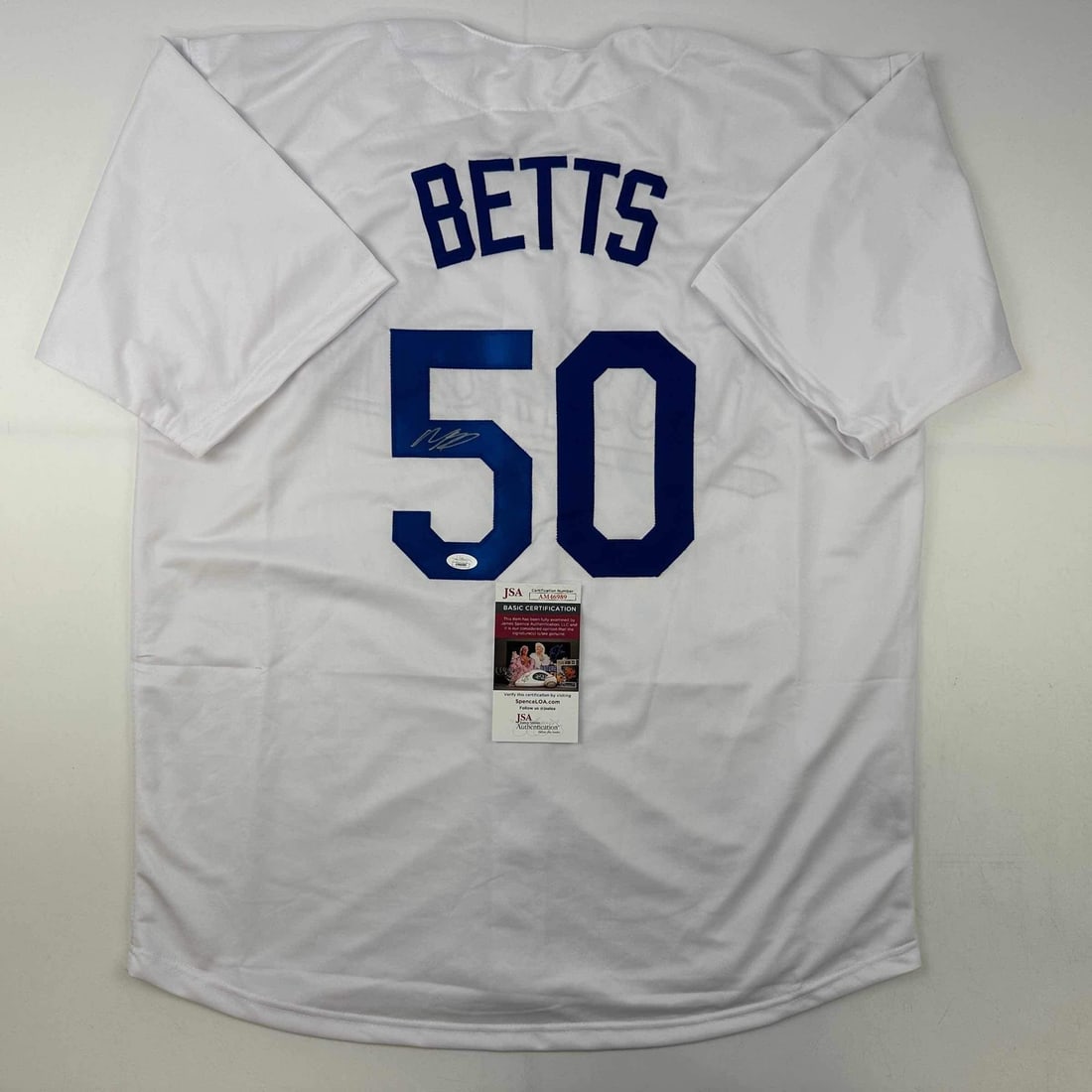 Autographed Mookie Betts Los Angeles Dodgers White Jersey JSA COA: Autographed Mookie Betts Los Angeles Dodgers White Jersey JSA COA This is an autographed Mookie Betts Los Angeles Dodgers white baseball jersey, featuring the player's name and number. The jersey is a