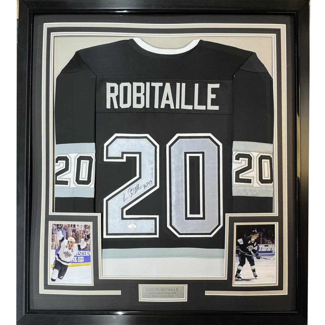 Framed Luc Robitaille HOF 09 Autographed Jersey 35x39 JSA COA: Framed Luc Robitaille HOF 09 Autographed Jersey 35x39 JSA COA This professionally framed and matted display features a black jersey autographed by Luc Robitaille, a celebrated NHL player and Hall of F