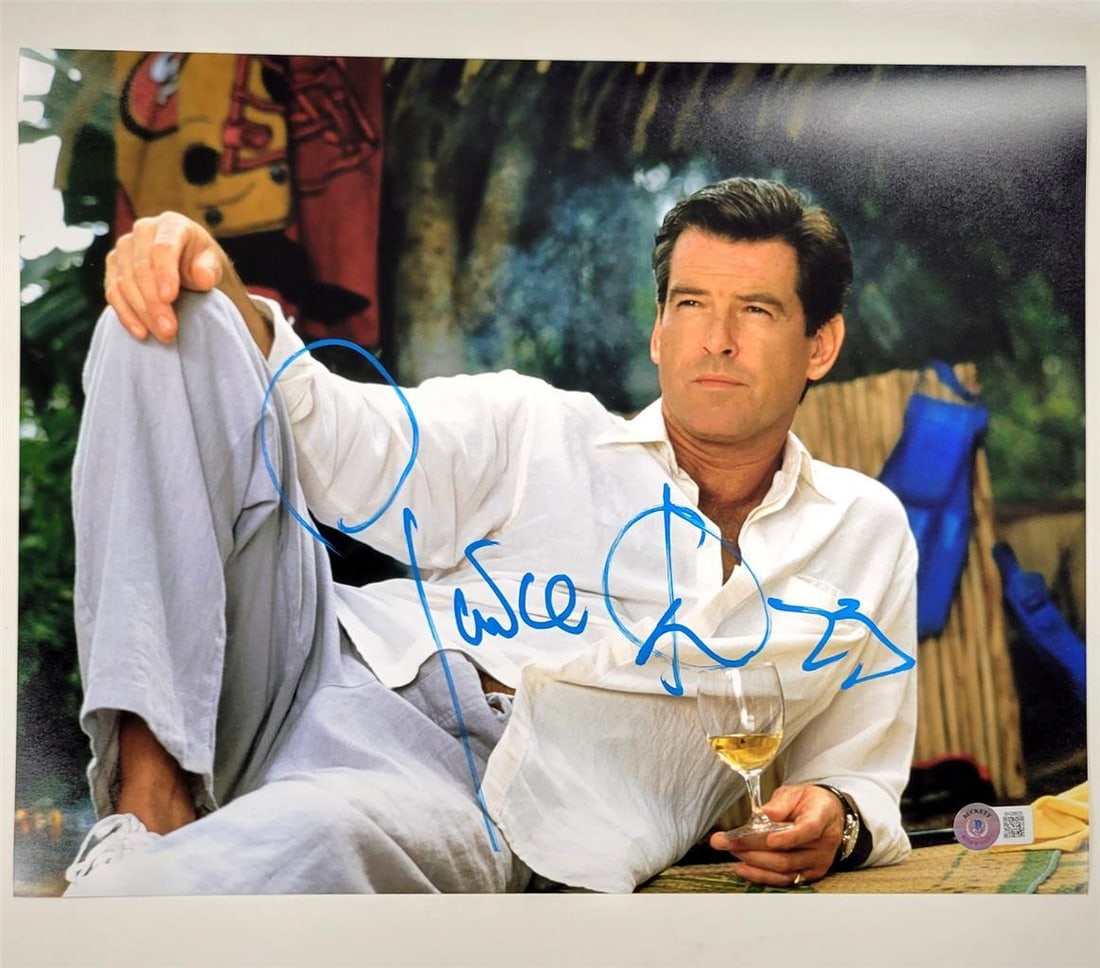 Pierce Brosnan Signed 11x14 James Bond Photo Beckett Authenticated: Pierce Brosnan Signed 11x14 James Bond Photo Beckett Authenticated This is an original 11x14 photograph featuring Pierce Brosnan as James Bond from the movie "Goldeneye." The photograph is authenticat