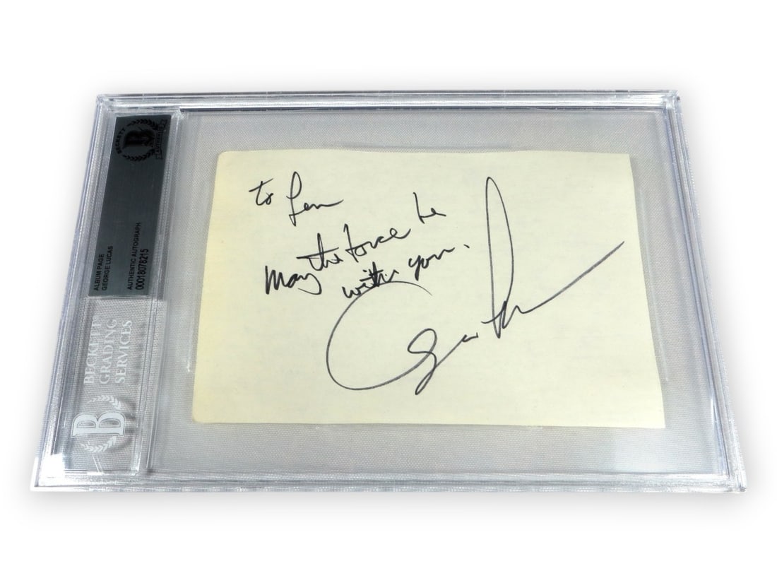 Beckett Authenticated George Lucas Signed Album Page With Star Wars Quote: Beckett Authenticated George Lucas Signed Album Page With Star Wars Quote This is an original album page signed by George Lucas, renowned creator of Star Wars, featuring the inscription "May the Force