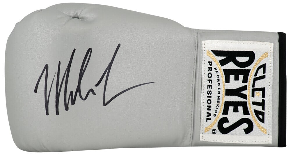 Mike Tyson Signed Cleto Reyes Silver Boxing Glove with COA: Mike Tyson Signed Cleto Reyes Silver Boxing Glove with COA This is a Mike Tyson signed Cleto Reyes silver boxing glove, a must-have for any boxing enthusiast. The glove is authenticated with a tamper-