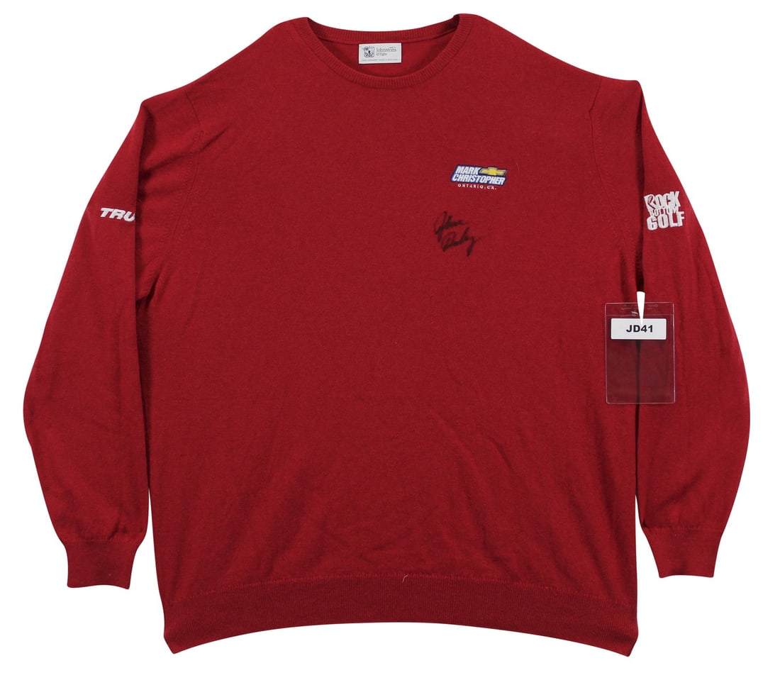 John Daly Signed Match Worn Red Cashmere Sweater Beckett Authenticated: John Daly Signed Match Worn Red Cashmere Sweater Beckett Authenticated This original, match-worn red cashmere sweater by Johnstons of Elgin has been personally signed by professional golfer John Daly.