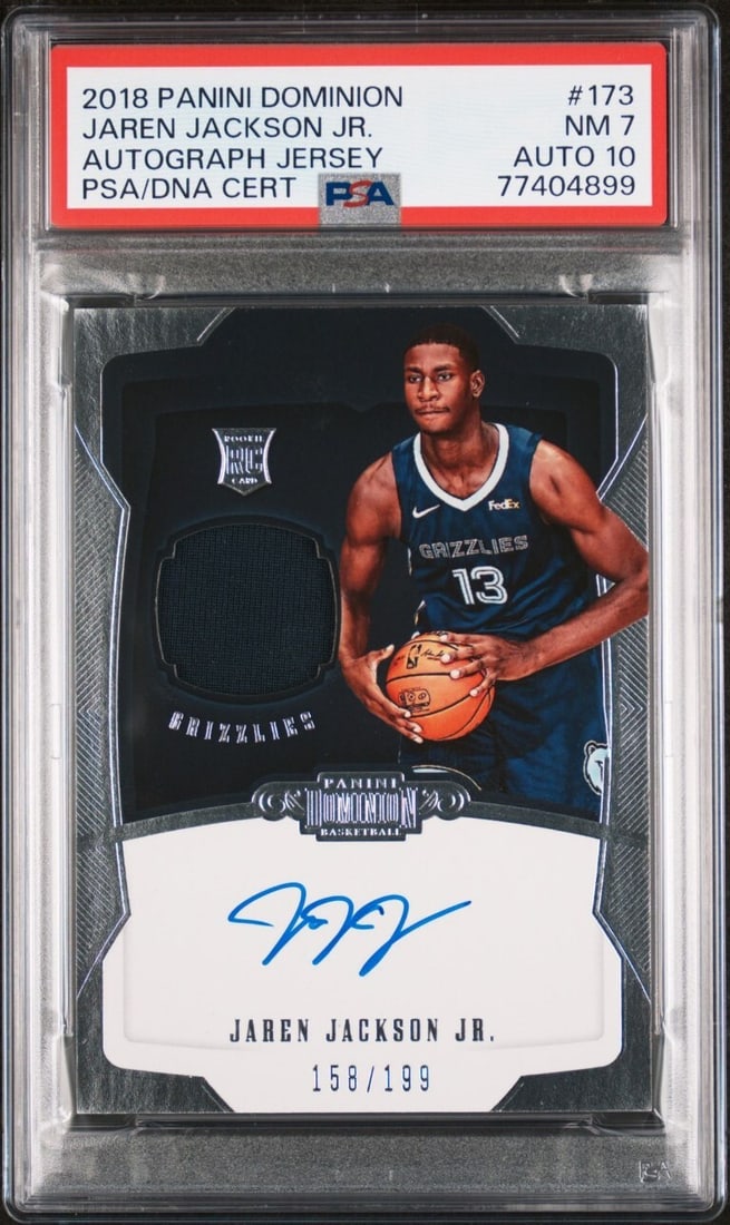 Jaren Jackson 2018 Panini Dominion Jersey Autograph RC PSA 7 #173: Jaren Jackson 2018 Panini Dominion Jersey Autograph RC PSA 7 #173 Celebrate the talent of Jaren Jackson with this 2018 Panini Dominion Jersey Autograph Basketball Card. This graded card (#173) feature