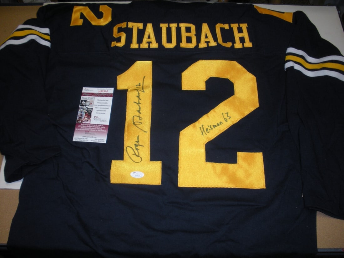 Signed Roger Staubach Jersey with JSA COA Navy and Cowboys Heisman 1963: Signed Roger Staubach Jersey with JSA COA Navy and Cowboys Heisman 1963 This pre-owned jersey is signed by Roger Staubach, commemorating his time with the Navy Midshipmen and his Heisman Trophy win in