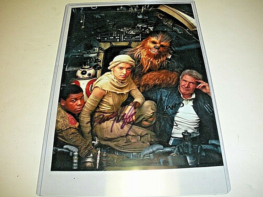 Star Wars Cast Signed Photograph With COA Featuring Four Actor Autographs: Star Wars Cast Signed Photograph With COA Featuring Four Actor Autographs This pre-owned signed photo features the autographs of Harrison Ford, Peter Mayhew, Daisy Ridley, and John Boyega from Star Wa