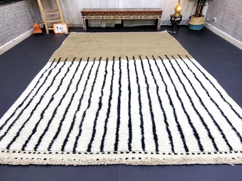 Handmade 9x5 Feet Soft Wool Rug from Morocco: Handmade 9x5 Feet Soft Wool Rug from Morocco Discover the charm of this Elegant Handmade Soft Wool Rug, meticulously handwoven in the Atlas Mountains by skilled Berber women weavers. Crafted with 100%