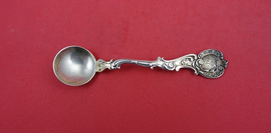 Shiebler Rococo Sterling Salt Spoon with Gold Wash 3.75 Inch: Shiebler Rococo Sterling Salt Spoon with Gold Wash 3.75 Inch This is a master salt spoon in the Rococo pattern by Shiebler, crafted from sterling silver with a light gold wash finish. The spoon measur