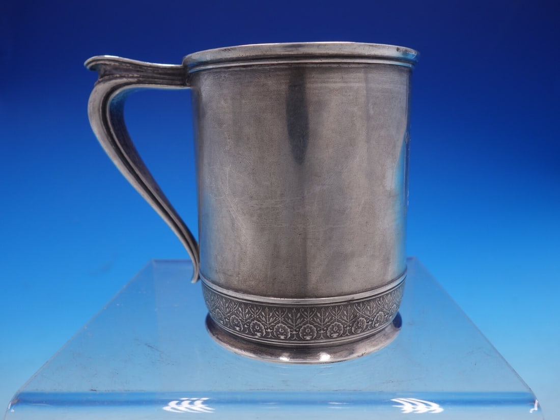 1870s English Sterling Silver Baby Cup with Tulip Design: 1870s English Sterling Silver Baby Cup with Tulip Design This exquisite vintage English silver baby cup dates back to the 1870s and features a charming border adorned with tulips and foliage. It is ma