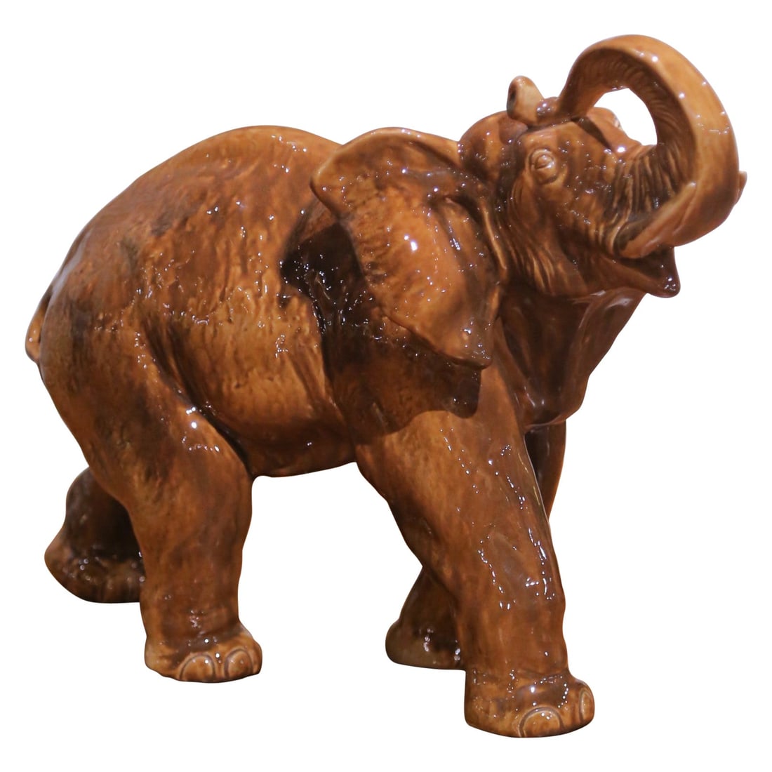 Italian Ceramic Elephant Figurine with Glazed Finish and Raised Trunk Mid-Century: Italian Ceramic Elephant Figurine with Glazed Finish and Raised Trunk Mid-Century This mid-century Italian glazed ceramic elephant sculpture, crafted circa 1950-1960, features a raised trunk in a gest