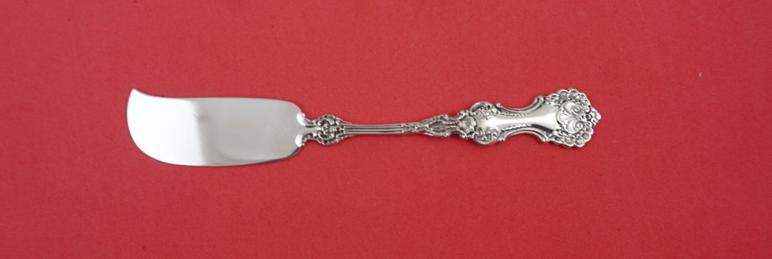 Whiting Pompadour Sterling Silver Butter Spreader 5 5/8" Flat Handle: Whiting Pompadour Sterling Silver Butter Spreader 5 5/8" Flat Handle Add a touch of elegance to your dining experience with this Pompadour butter spreader by Whiting. Crafted from high-quality sterlin
