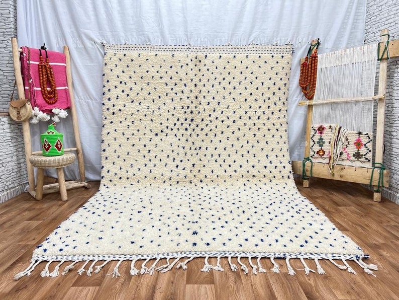 Handwoven Soft White Dotted Rug 100% Sheep Wool Morocco: Handwoven Soft White Dotted Rug 100% Sheep Wool Morocco Experience the charm of handcrafted elegance with this Soft White Dotted Rug. Skillfully handwoven in the Atlas Mountains by local Berber women,