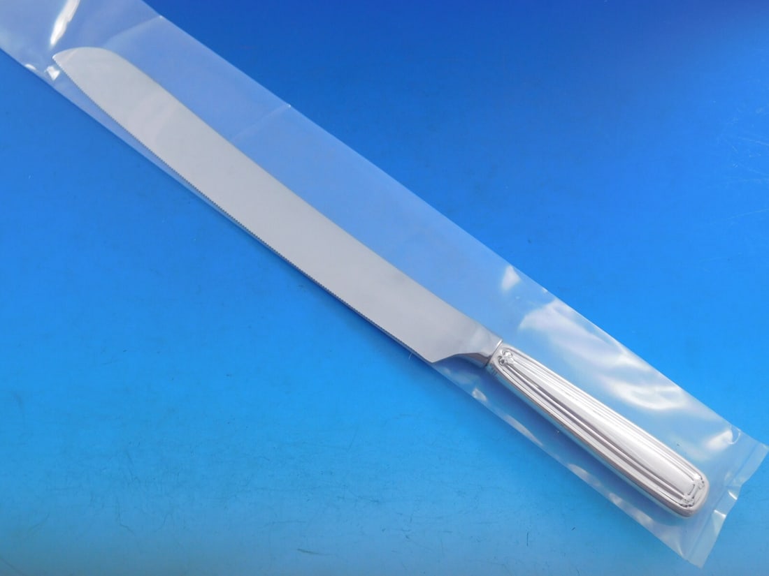 Tiffany & Co. Saint Dunstan Sterling Silver Wedding Cake Knife 12": Tiffany & Co. Saint Dunstan Sterling Silver Wedding Cake Knife 12" Introducing the exquisite Saint Dunstan Wedding Cake Knife by Tiffany & Co., meticulously crafted from sterling silver. This elegant