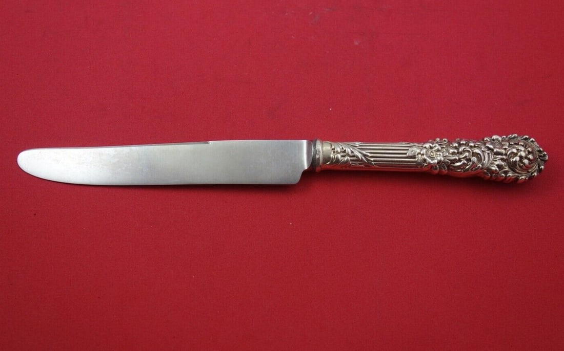 Reed and Barton Trajan Sterling Silver Dinner Knife 10 Inch: Reed and Barton Trajan Sterling Silver Dinner Knife 10 Inch This exquisite dinner knife from the Trajan pattern by Reed and Barton features a hollow handle crafted from sterling silver and a finely de