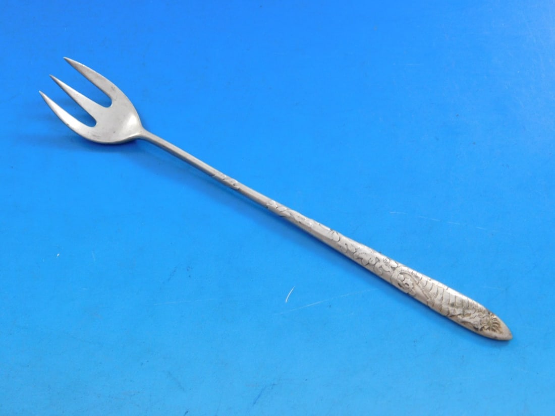 Tiffany Lap Over Edge Sterling Seahorse Cocktail Oyster Fork 5 5/8 Inch: Tiffany Lap Over Edge Sterling Seahorse Cocktail Oyster Fork 5 5/8 Inch This exquisite cocktail/oyster fork, crafted by Tiffany & Co., showcases the elegant Lap Over Edge Acid Etched pattern. Made of