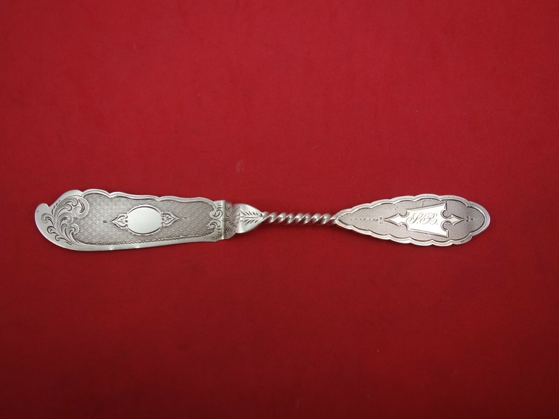 Engine Turned Coin Silver Master Butter Knife Monogrammed 6 3/4": Engine Turned Coin Silver Master Butter Knife Monogrammed 6 3/4" This exquisite master butter knife features a sleek flat handle with an elegant engine-turned design. Crafted from coin silver, this pi