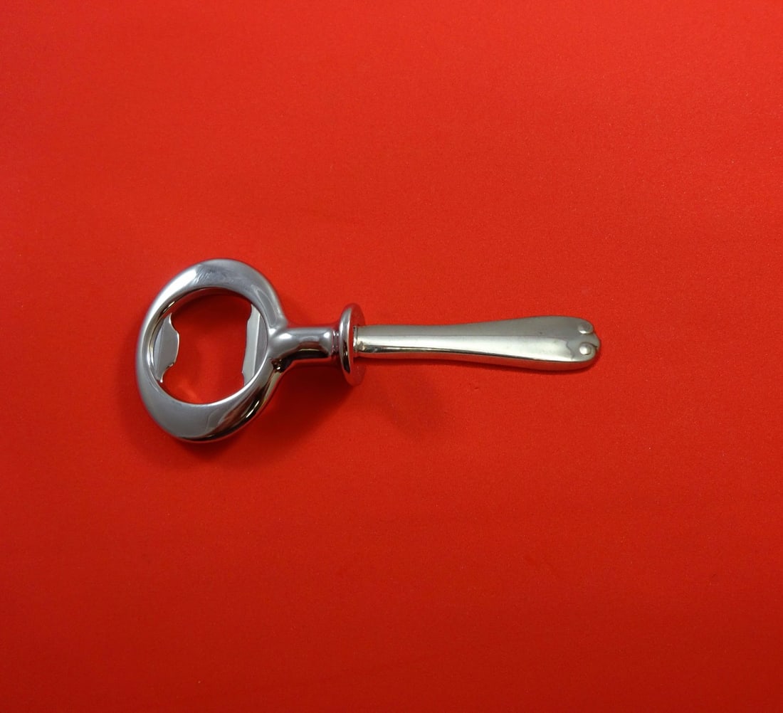 Tiffany & Co. Flemish Sterling Silver Custom Bottle Opener 6": Tiffany & Co. Flemish Sterling Silver Custom Bottle Opener 6" Introducing the Flemish by Tiffany & Co. Sterling Silver Bottle Opener, a luxurious addition to any barware collection. Crafted in the ico