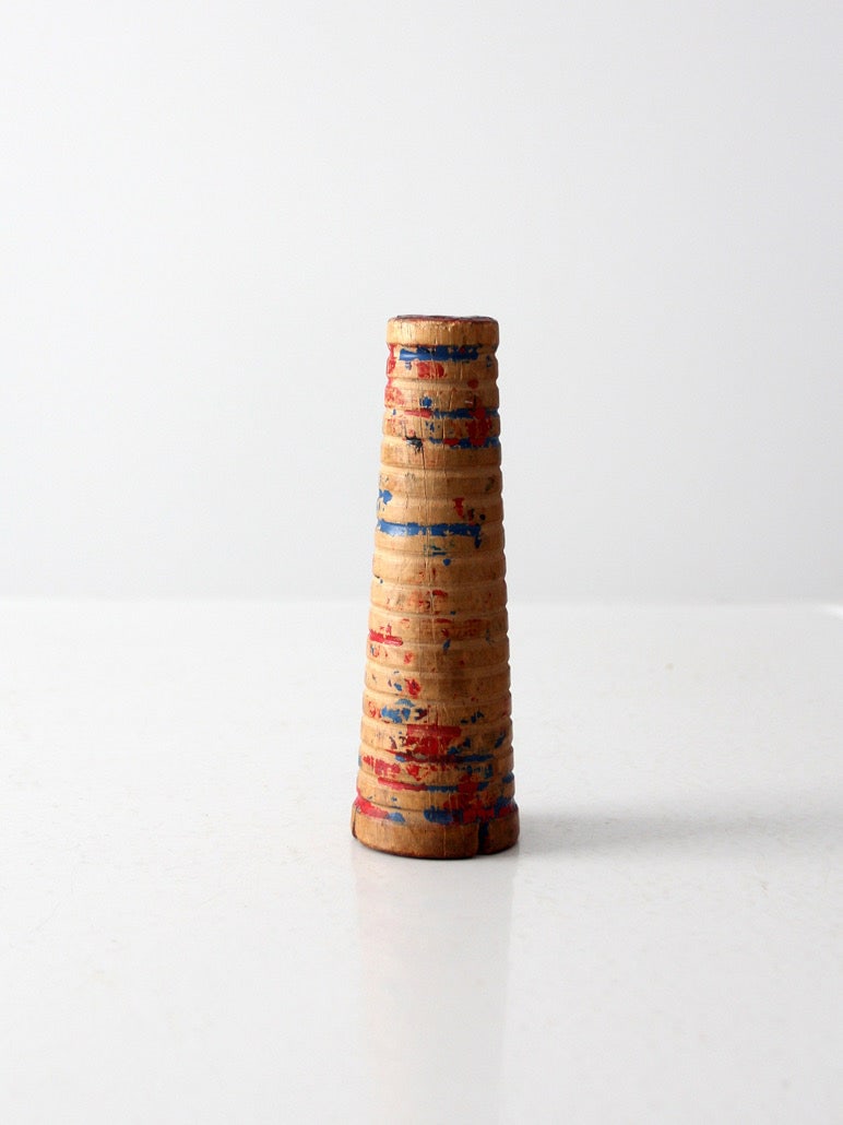 Turned Wood Industrial Bobbin Spool with Red and Blue Paint Traces: Turned Wood Industrial Bobbin Spool with Red and Blue Paint Traces This early textile mill bobbin is crafted from turned wood and features carved rings with layered traces of red and blue paint. Its