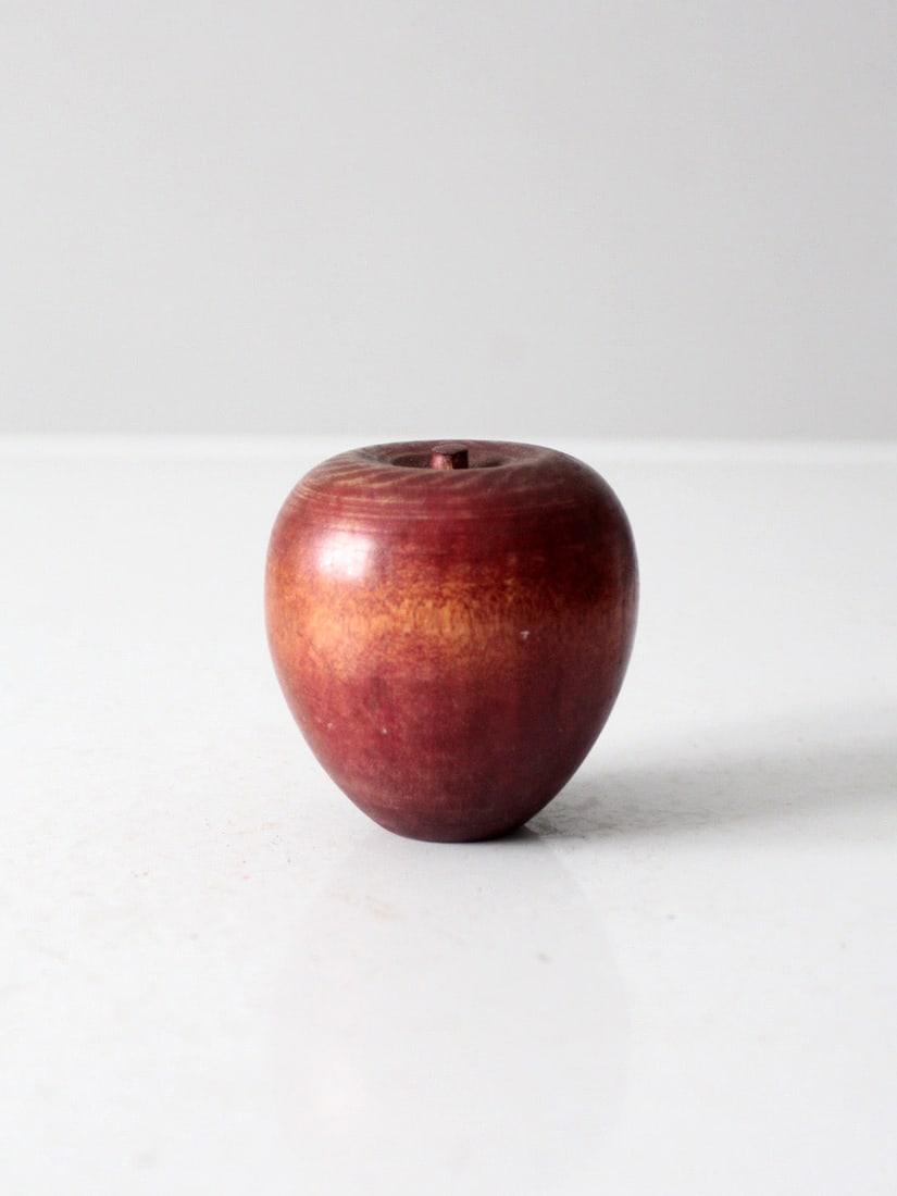 Mid Century Wooden Apple Paperweight Natural Decor Accent: Mid Century Wooden Apple Paperweight Natural Decor Accent This mid-century wooden apple paperweight showcases a beautifully turned design in warm reddish tones, featuring a smooth grain and a small ca
