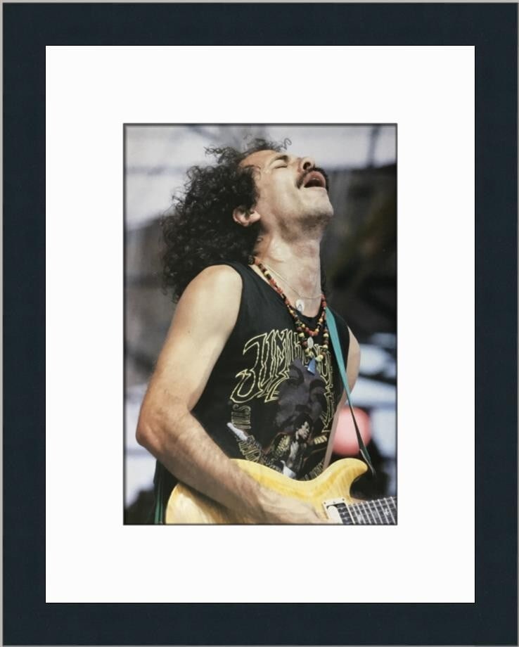 Carlos Santana Live Aid Concert Custom Framed Reproduction Print: Carlos Santana Live Aid Concert Custom Framed Reproduction Print This custom framed print captures the electrifying performance of Carlos Santana at the Live Aid concert. The image measures 10" x 7" a