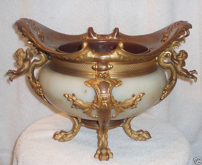 18th Century Louis XIV Dore Bronze Centerpiece with Cherubs and Lion Paws: 18th Century Louis XIV Dore Bronze Centerpiece with Cherubs and Lion Paws This exquisite 18th century Louis XIV dore bronze centerpiece showcases remarkable craftsmanship with intricate patina details