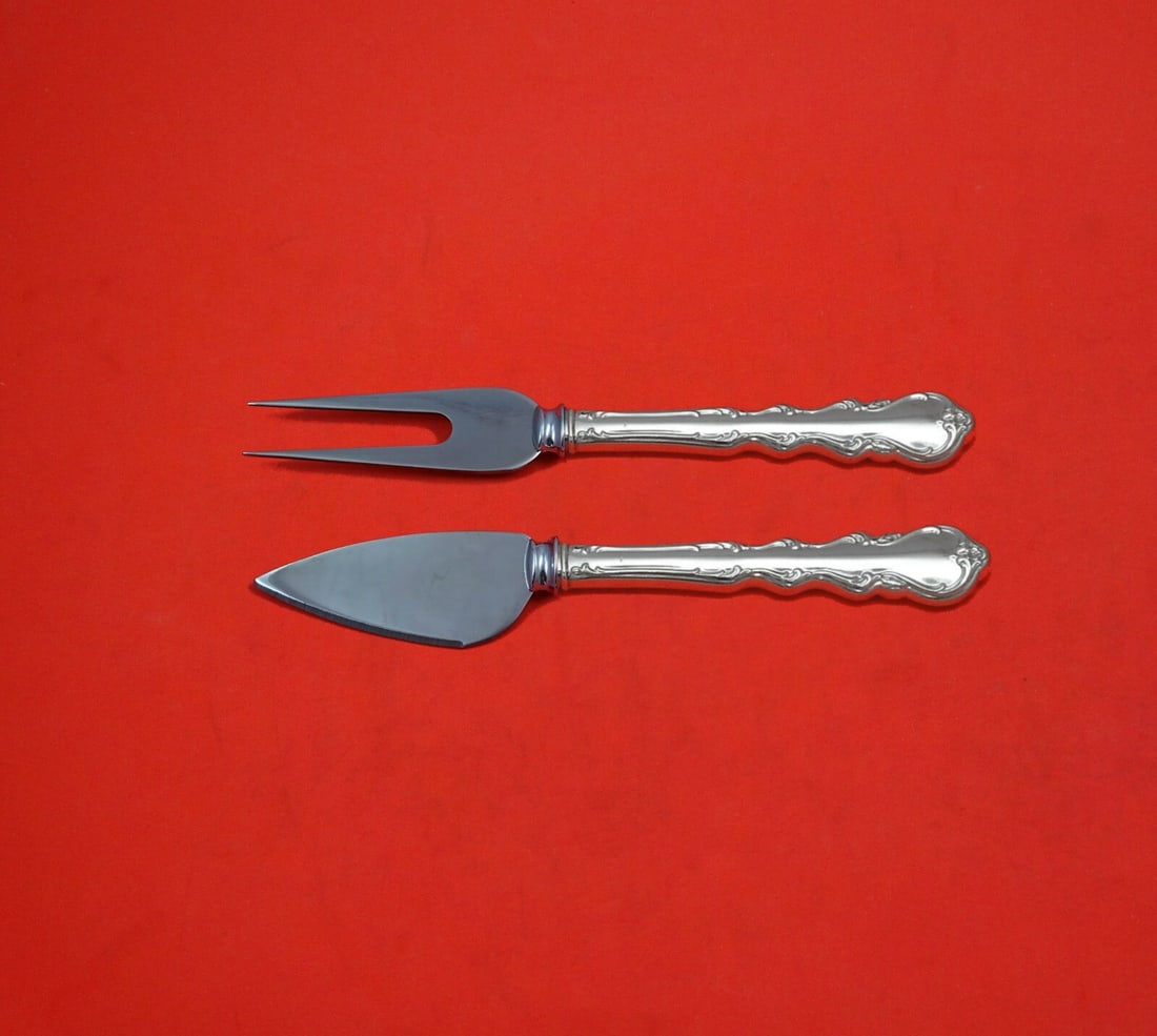 International Sterling Silver Angelique 2pc Cheese Serving Set: International Sterling Silver Angelique 2pc Cheese Serving Set Elevate your cheese serving experience with the Angelique Serving Set by International. This exquisite 2-piece set is crafted from sterli