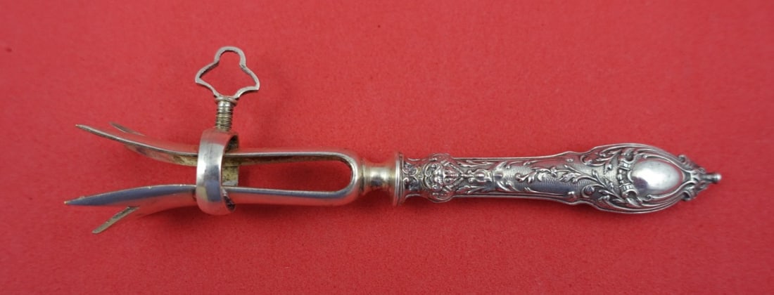 French Sterling Silver Bone Holder with Figural Handle 4.25": French Sterling Silver Bone Holder with Figural Handle 4.25" Discover the elegance of this French Sterling Silver Bone Holder, crafted by various makers. This exquisite piece features a hollow handle