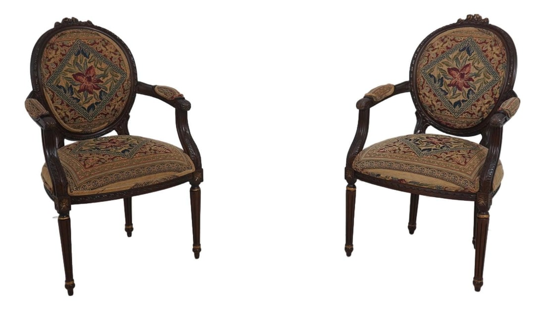 Set of Two Mahogany French Medallion Armchairs with Needlepoint Seats: Set of Two Mahogany French Medallion Armchairs with Needlepoint Seats This pair of Louis XVI style armchairs features finely carved mahogany frames with gilt painted accents and medallion backs. The c