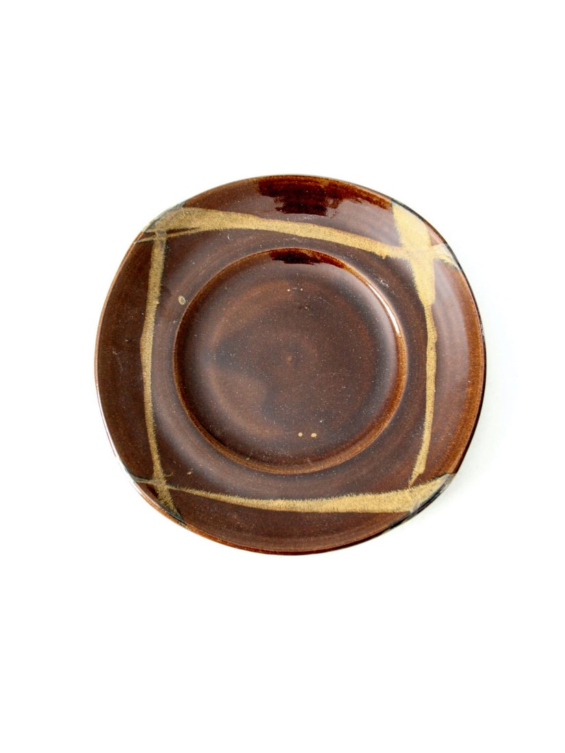 Handcrafted Vintage Pottery Plate with Gold Accents 13 inch: Handcrafted Vintage Pottery Plate with Gold Accents 13 inch This vintage studio pottery plate showcases a unique rounded square design, handcrafted with a rich brown glaze complemented by elegant gold