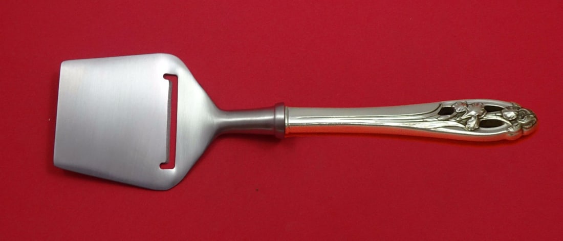 International Silver Iris Cheese Plane Sterling Silver Custom 8.25": International Silver Iris Cheese Plane Sterling Silver Custom 8.25" Introducing the Silver Iris Cheese Plane by International, a stylish addition to your serving pieces. Crafted from high-quality ster