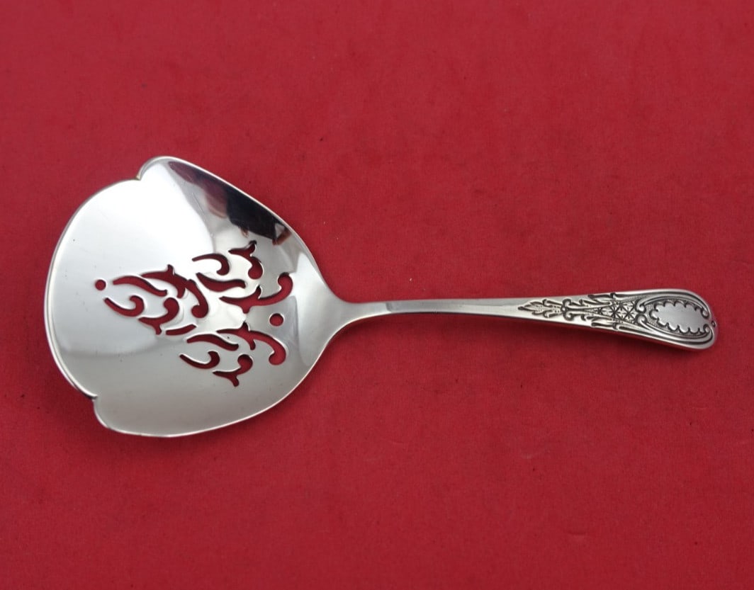 Tuttle Sterling Silver Windsor Castle Slotted Nut Spoon 4 3/4": Tuttle Sterling Silver Windsor Castle Slotted Nut Spoon 4 3/4" This exquisite Sterling Silver Nut Spoon is crafted in the elegant Windsor Castle pattern by Tuttle. Measuring 4 3/4 inches, this slotted