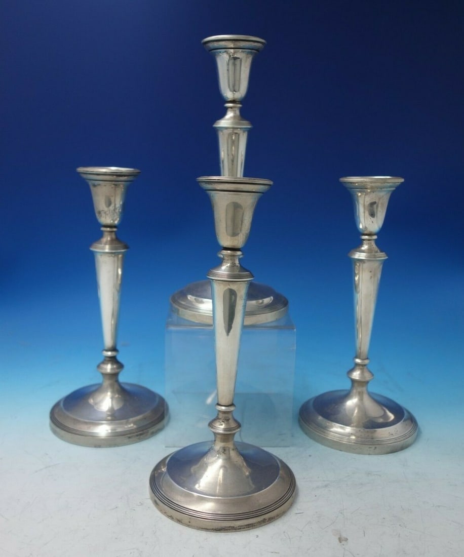 Graff Washbourne Dunn Sterling Silver 4pc Candlestick Set Reproduction: Graff Washbourne Dunn Sterling Silver 4pc Candlestick Set Reproduction Enhance your home decor with this exquisite four-piece candlestick set by Graff Washbourne & Dunn, crafted in sterling silver. Th
