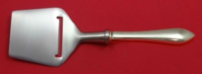 Dominick & Haff Pointed Antique Sterling Silver Cheese Plane 8 1/4": Dominick & Haff Pointed Antique Sterling Silver Cheese Plane 8 1/4" This exquisite cheese plane is crafted from sterling silver by Dominick & Haff, featuring the elegant Pointed Antique pattern. The c