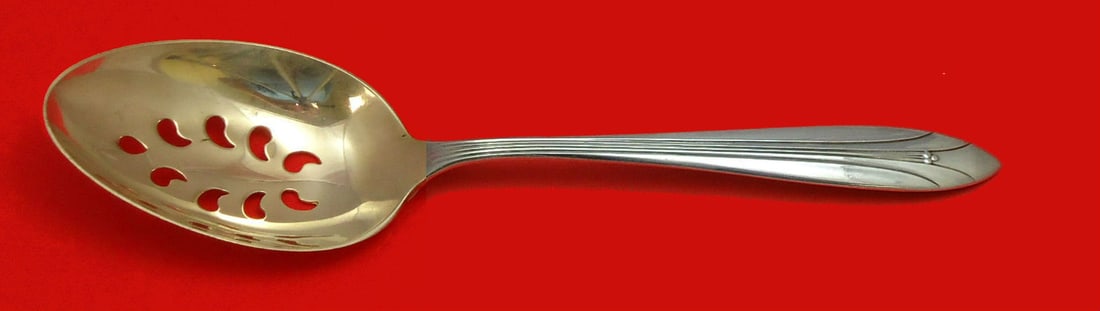 International Sterling Silver Elsinore Slotted Serving Spoon 9-Hole 8 5/8 in: International Sterling Silver Elsinore Slotted Serving Spoon 9-Hole 8 5/8 in This exquisite slotted serving spoon is crafted from high-quality sterling silver and features the elegant Elsinore pattern