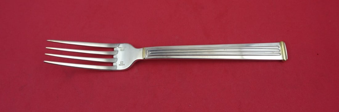 Christofle Triade Gold Accent Silverplate Dinner Fork 7 5/8": Christofle Triade Gold Accent Silverplate Dinner Fork 7 5/8" Elevate your dining experience with this exquisite Triade Gold Accent dinner fork by Christofle. This elegant piece showcases the refined c