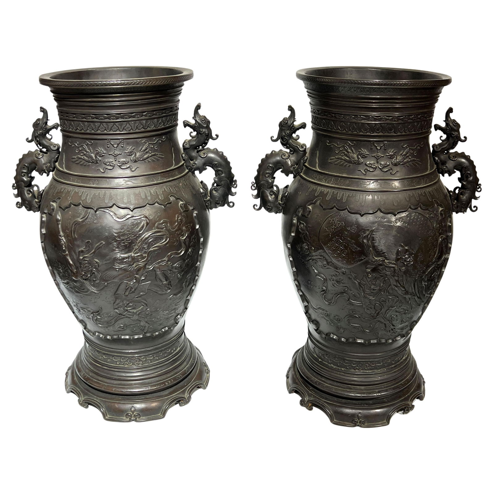 Set of Two Meiji Period Japanese Bronze Vases with Dragon Handles: Set of Two Meiji Period Japanese Bronze Vases with Dragon Handles This set includes two large Japanese bronze vases from the Meiji period, each featuring a rich dark brown patina. The vases are distin