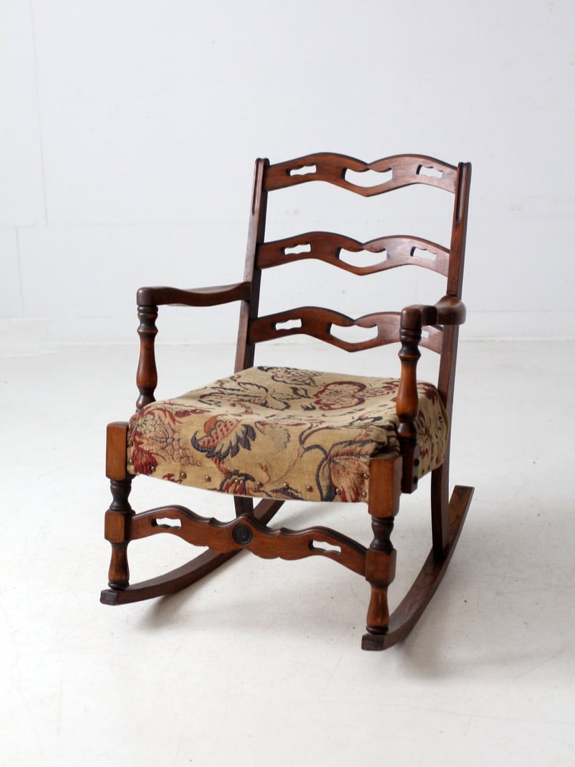 Colonial Revival Antique Rocking Chair with Floral Tapestry Seat: Colonial Revival Antique Rocking Chair with Floral Tapestry Seat This exquisite late 19th- to early 20th-century Colonial Revival rocking chair showcases a timeless design with shaped ladder-back slat