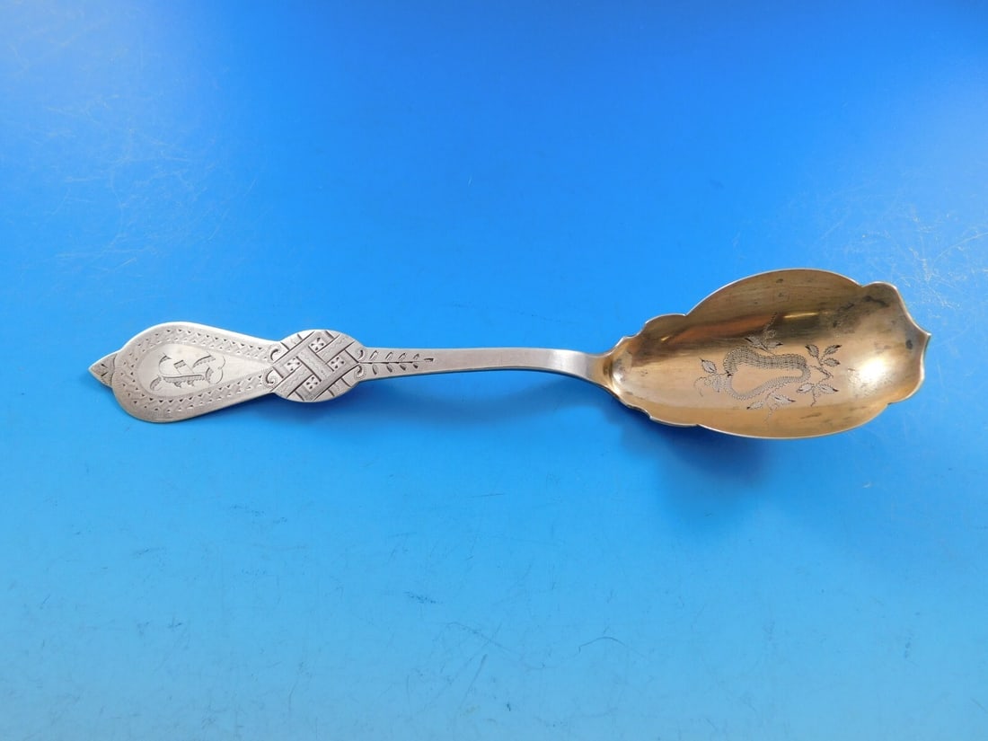 Gurney Bros Brite Cut Coin Silver Sugar Spoon Gold Washed 6 1/4": Gurney Bros Brite Cut Coin Silver Sugar Spoon Gold Washed 6 1/4" This exquisite Brite Cut coin silver sugar spoon, crafted by Gurney Bros, is a stunning representation of fine craftsmanship from the p