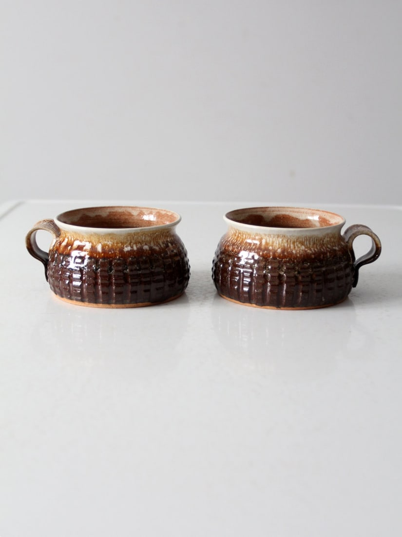 Handmade Vintage Studio Pottery Mugs Set of 2 Signed Geometric Design: Handmade Vintage Studio Pottery Mugs Set of 2 Signed Geometric Design This charming pair of vintage studio pottery mugs showcases a beautiful brown and cream glaze that accentuates the intricate etche