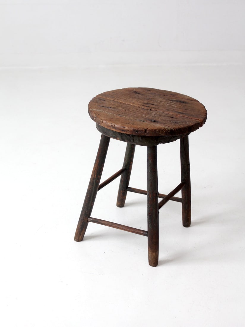 Antique Rustic Wood Stool with Thick Seat and Splayed Legs: Antique Rustic Wood Stool with Thick Seat and Splayed Legs Explore the charm of this Antique Primitive Wood Stool, featuring a thick, round seat supported by four back-splayed legs connected by simple
