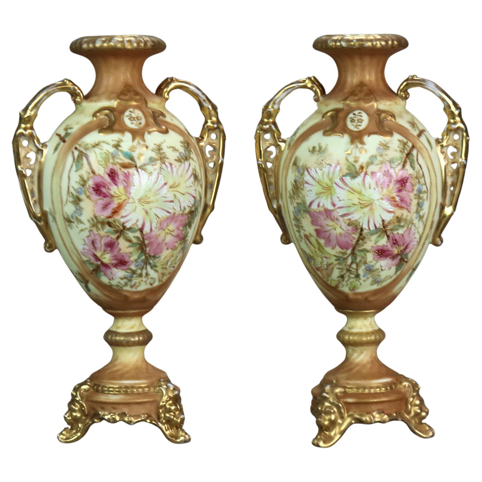 Set of Two Rudolstadt Porcelain Urns with Gilt and Hand Painted Floral Design: Set of Two Rudolstadt Porcelain Urns with Gilt and Hand Painted Floral Design This pair of antique Rudolstadt porcelain urns features hand-painted floral designs and gilt accents. Crafted in the late