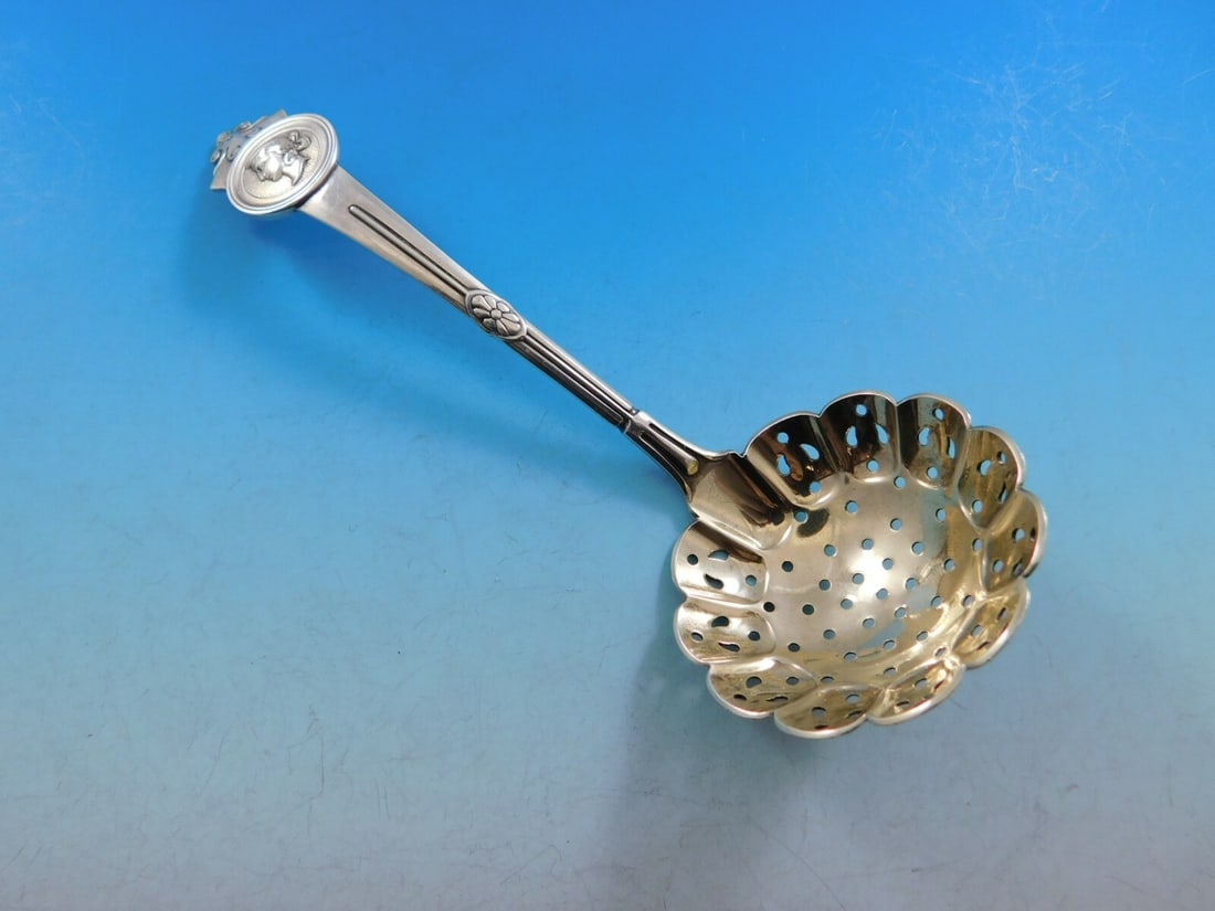 Gorham Medallion Sterling Silver Sugar Sifter Gold Washed 6 1/8": Gorham Medallion Sterling Silver Sugar Sifter Gold Washed 6 1/8" This exquisite sugar sifter, crafted by Gorham in the 19th century, showcases the intricate Medallion pattern. Measuring 6 1/8" in leng