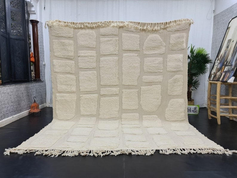 Authentic Handmade Moroccan Berber Wool Rug 9.84 x 6.56 Feet: Authentic Handmade Moroccan Berber Wool Rug 9.84 x 6.56 Feet Experience the elegance of this authentic Soft White Engraved Handmade Moroccan Berber Wool Area Rug. Handwoven in the Atlas Mountains by s